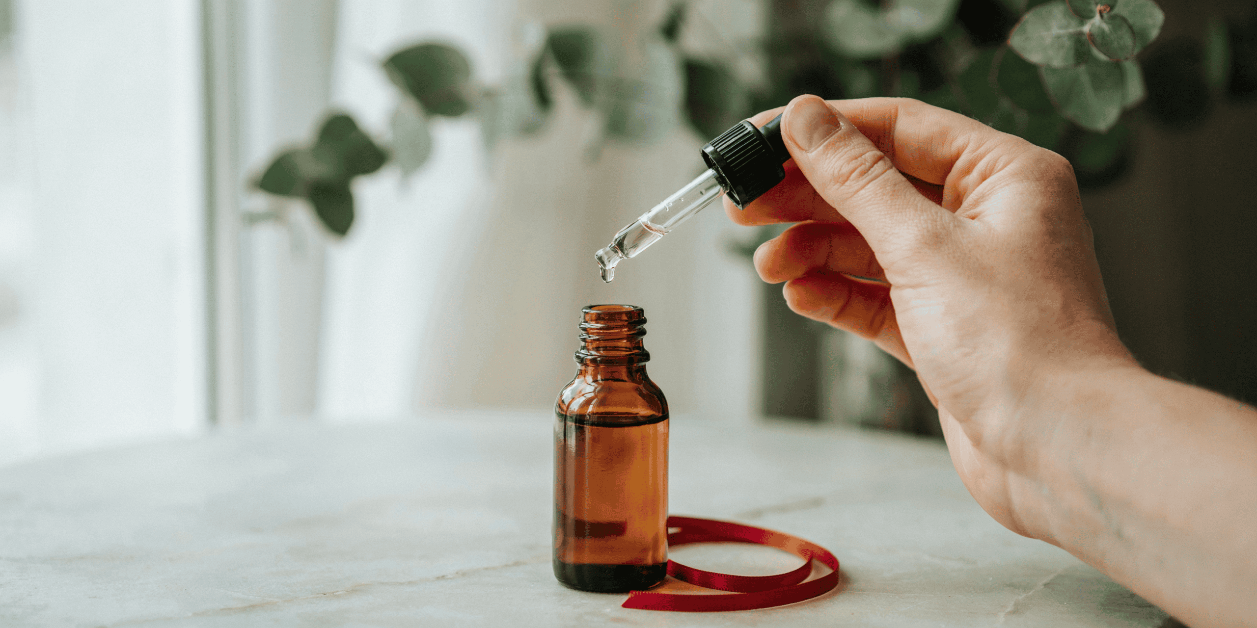 A few allergy drops being placed from a dropper bottle — sublingual immunotherapy at home